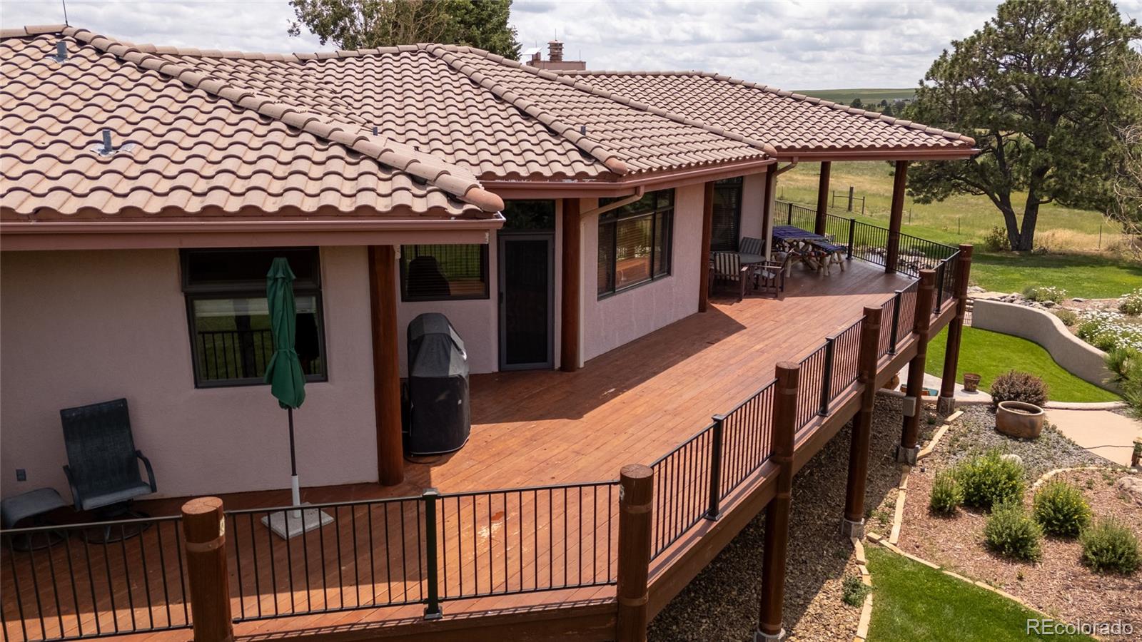 11503 East Smith Road Elbert, CO 80106 - Photo 10 of 44 a view of a house with backyard and deck