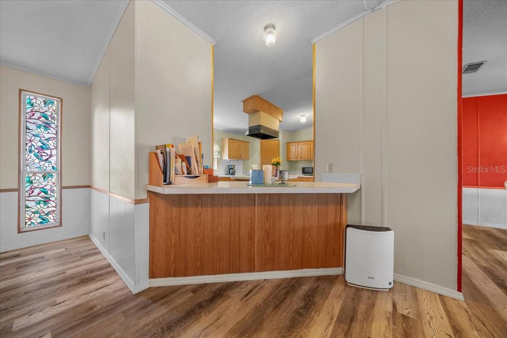 10865 Southeast Timucuan Road Summerfield, FL 34491 - Photo 14 of 35 a view of a hallway with wooden floor and cabinet