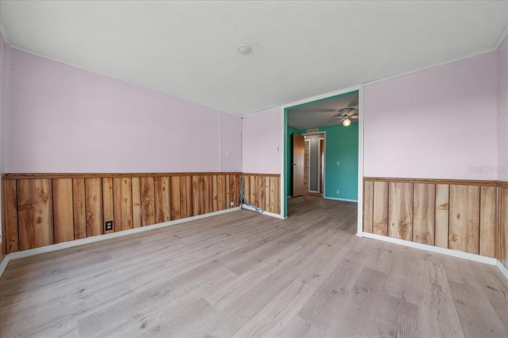 10865 Southeast Timucuan Road Summerfield, FL 34491 - Photo 28 of 35 a view of an empty room with wooden floor