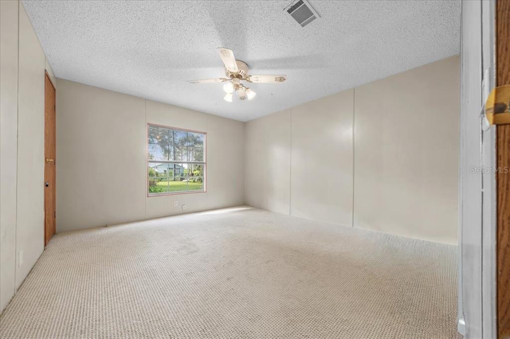 10865 Southeast Timucuan Road Summerfield, FL 34491 - Photo 32 of 35 an empty room with windows and fan