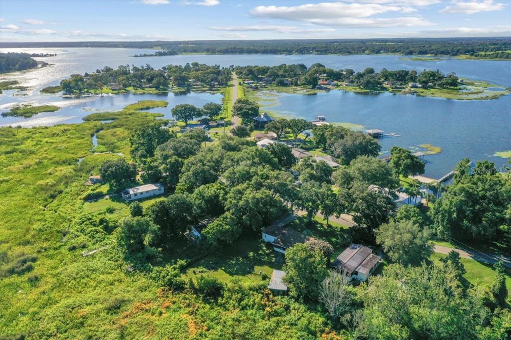 10865 Southeast Timucuan Road Summerfield, FL 34491 - Photo 5 of 35 an aerial view of green landscape with trees houses and lake view