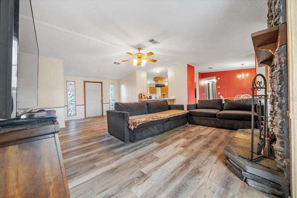 10865 Southeast Timucuan Road Summerfield, FL 34491 - Photo 9 of 35 a living room with furniture and a chandelier