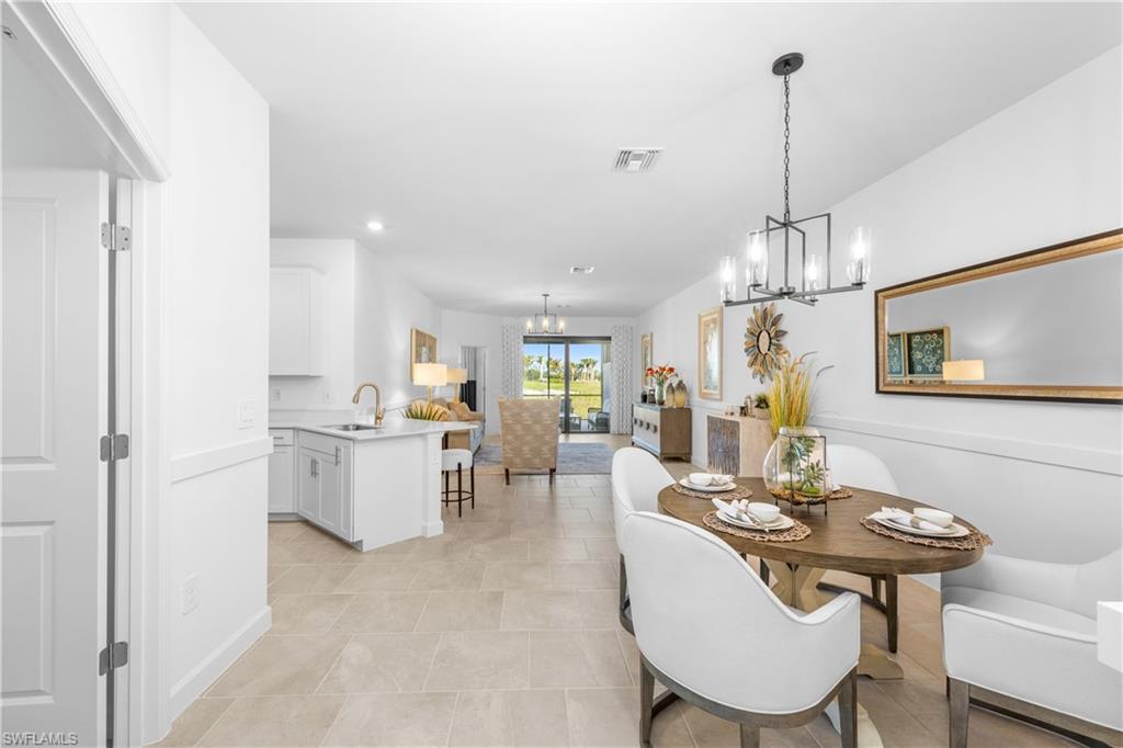 14656 Ballast Way Alva, FL 33920 - Photo 15 of 30 a view of a dining room and livingroom with furniture wooden floor a chandelier