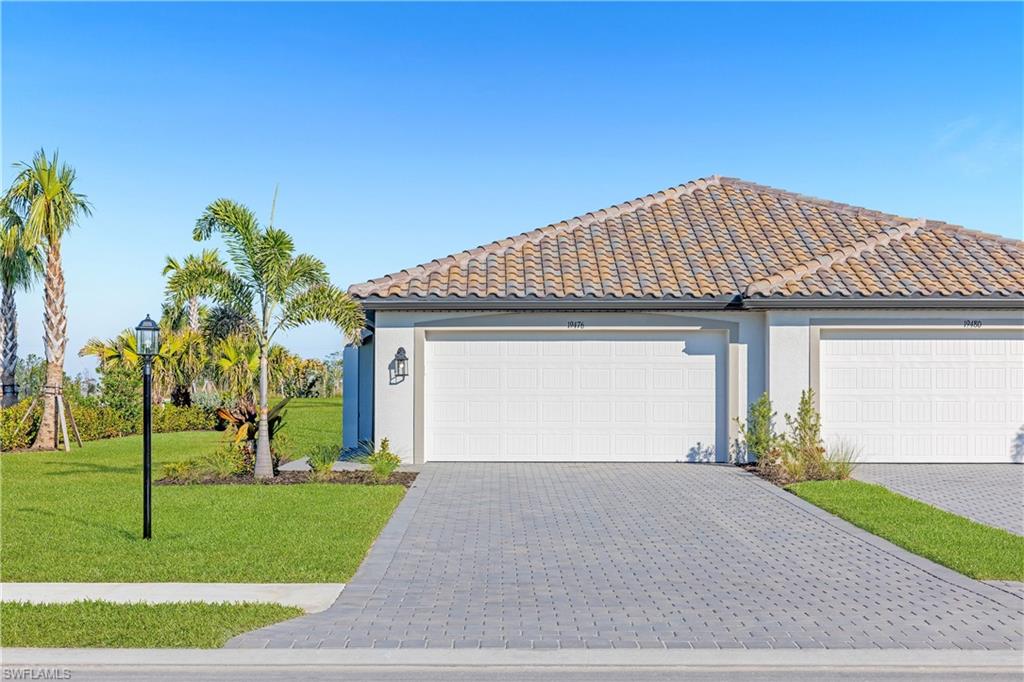 14656 Ballast Way Alva, FL 33920 - Photo 2 of 30 a front view of a house with a yard and garage