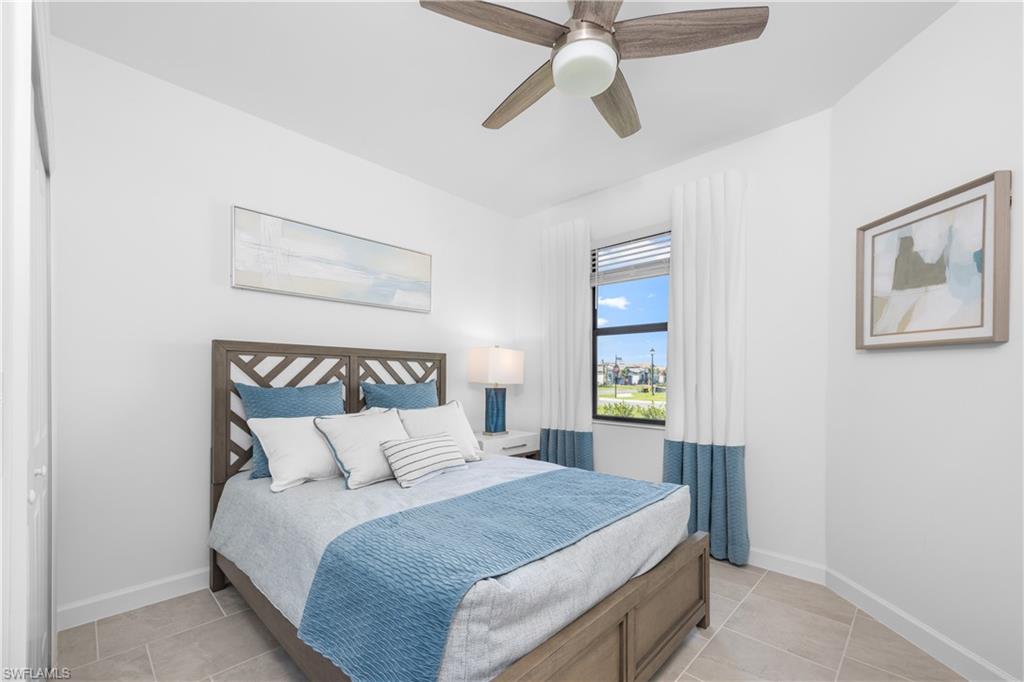 14656 Ballast Way Alva, FL 33920 - Photo 25 of 30 a bedroom with a bed and a chandelier
