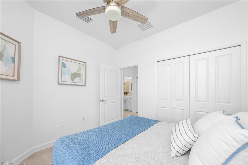 14656 Ballast Way Alva, FL 33920 - Photo 26 of 30 a bedroom with a bed and a chandelier
