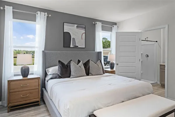 a bedroom with a large bed and a dresser