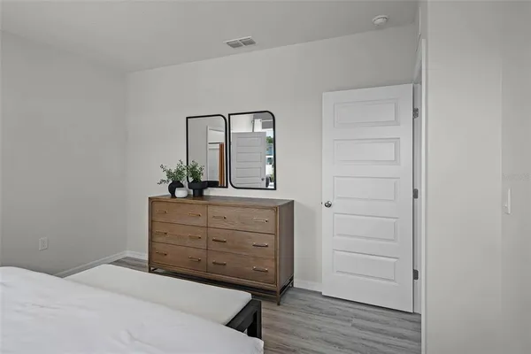 a bedroom with a bed and a dresser