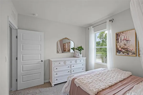 a bedroom with a bed and a dresser