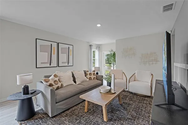 a living room with furniture and a lamp