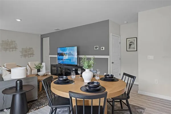 a dining room with furniture and wooden floor
