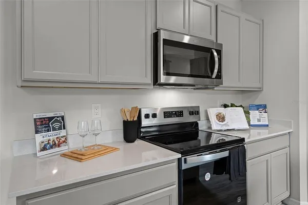 a kitchen with a stove and a microwave