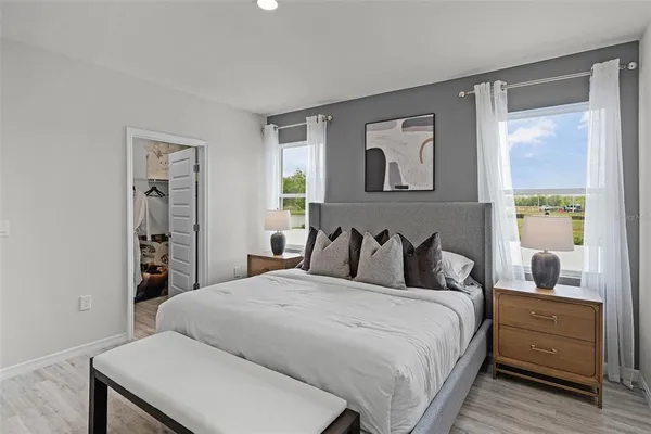 a bedroom with a large bed and a window