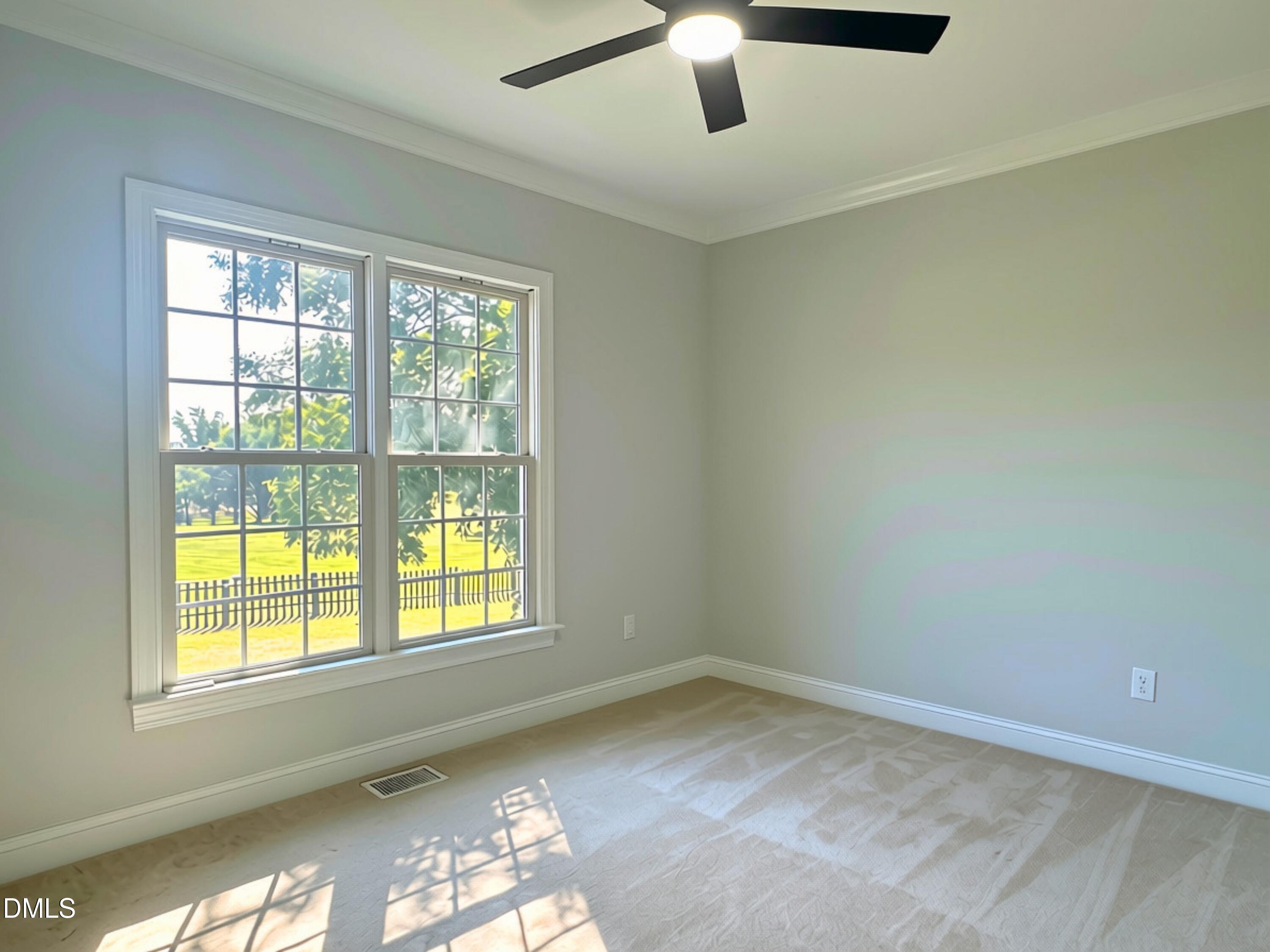 3100 Donlin Drive Wake Forest, NC 27587 - Photo 32 of 67 Dual pane windows, neutral wall tones, crown molding, ceiling fan, and carpeted flooring
