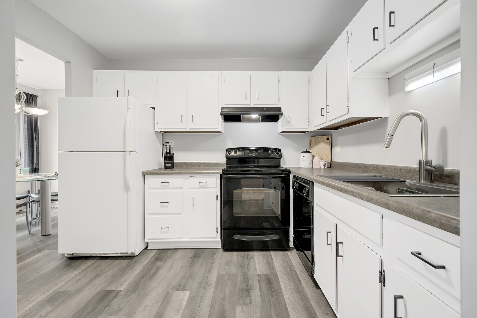 420 Walnut Creek Road, Unit 3406 Lisle, IL 60532 - Photo 8 of 21 a kitchen with granite countertop white cabinets and white appliances