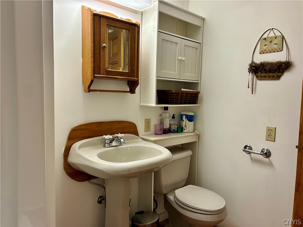 2676 County Rte 22 Orwell, NY 13144 - Photo 32 of 32 A classic pedestal sink stands next to built-in st