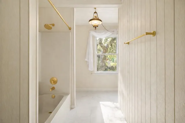 a living room with a black white checkered floor with couches chair and a coffee table