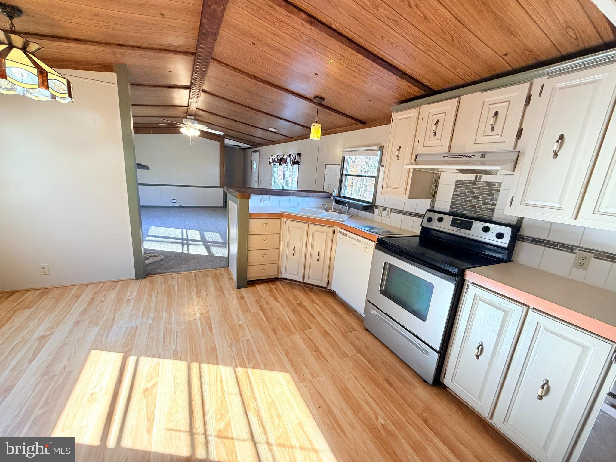 453 Upper Bailey Road Newport, PA 17074 - Photo 11 of 31 a kitchen with granite countertop a stove a sink and white cabinets