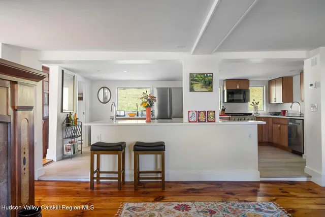 a bed sitting in front of a window next to a window
