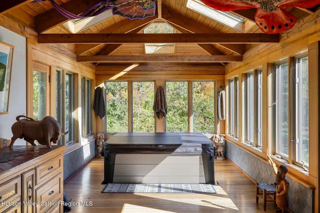 a bedroom with a bed and painting on the wall