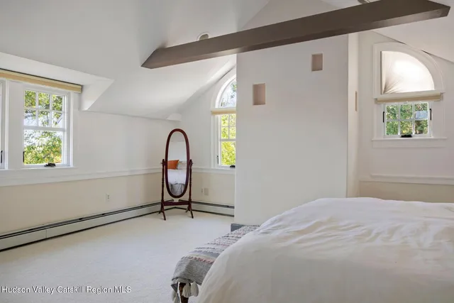 a front view of a house with garden and sitting area