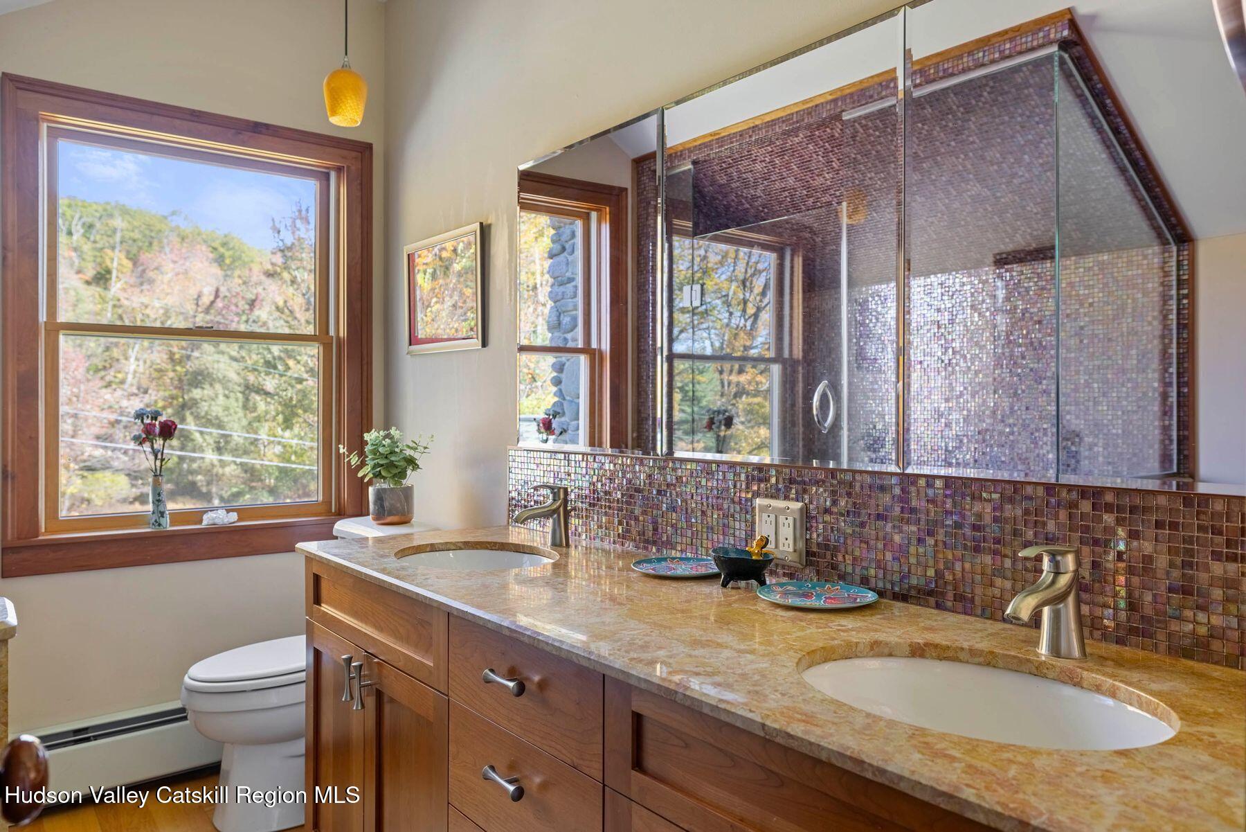 114 Chase Road Shokan, NY 12481 - Photo 46 of 68 a bathroom with a granite countertop sink mirror toilet and next to a window