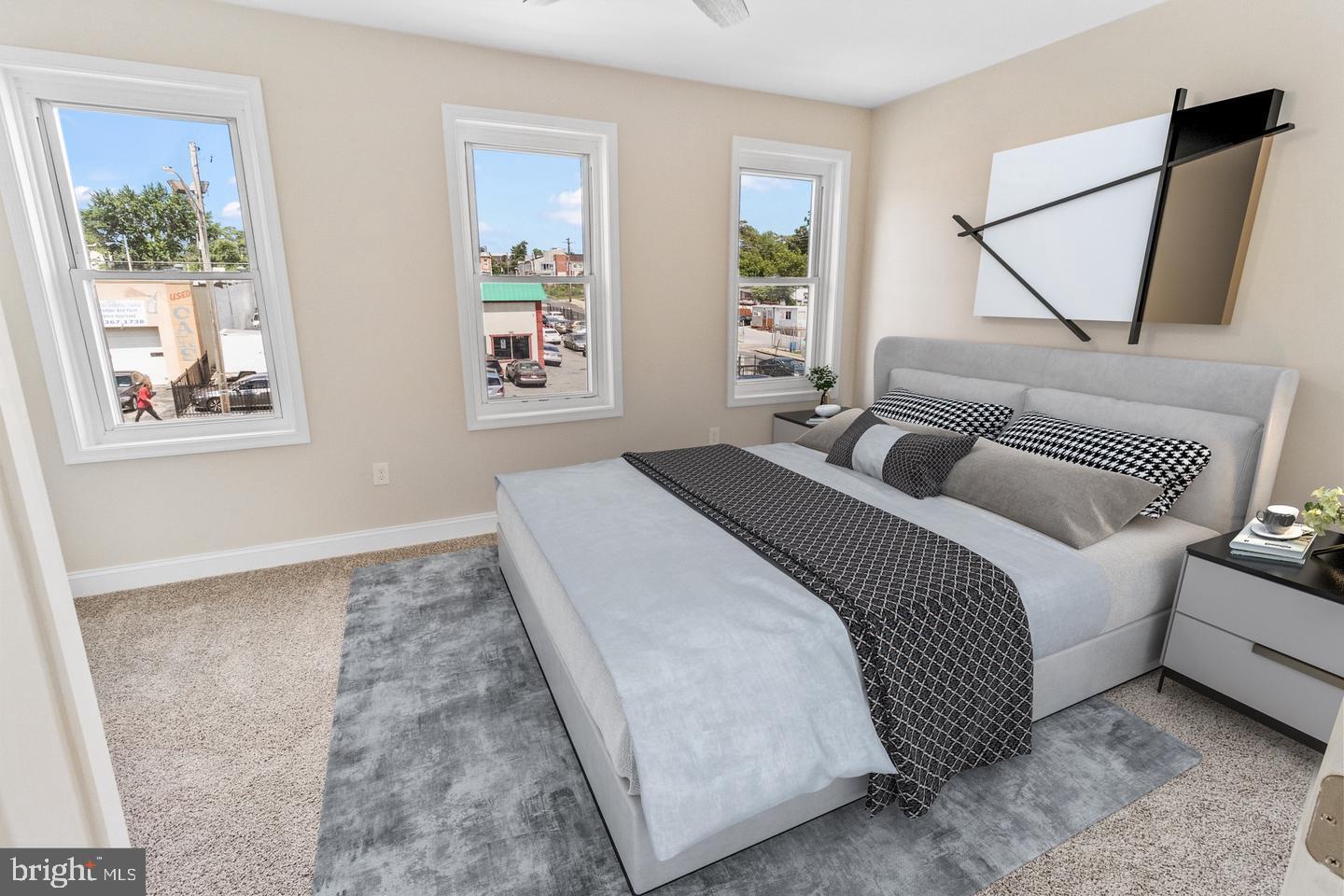 4206 Reisterstown Road Baltimore, MD 21215 - Photo 10 of 14 a bedroom with a bed and a couch