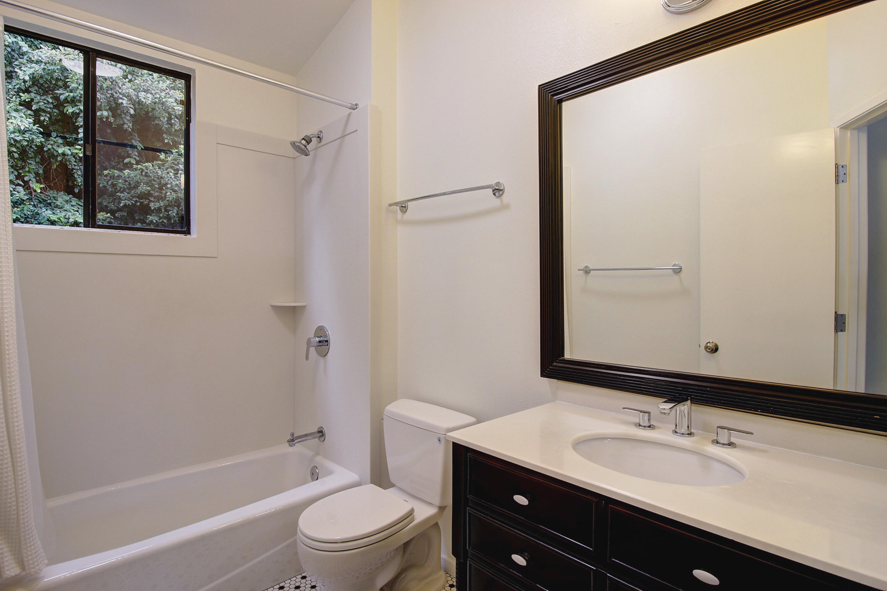 1624 Bath Street, Unit B Santa Barbara, CA 93101 - Photo 13 of 16 a bathroom with a granite countertop sink toilet and shower