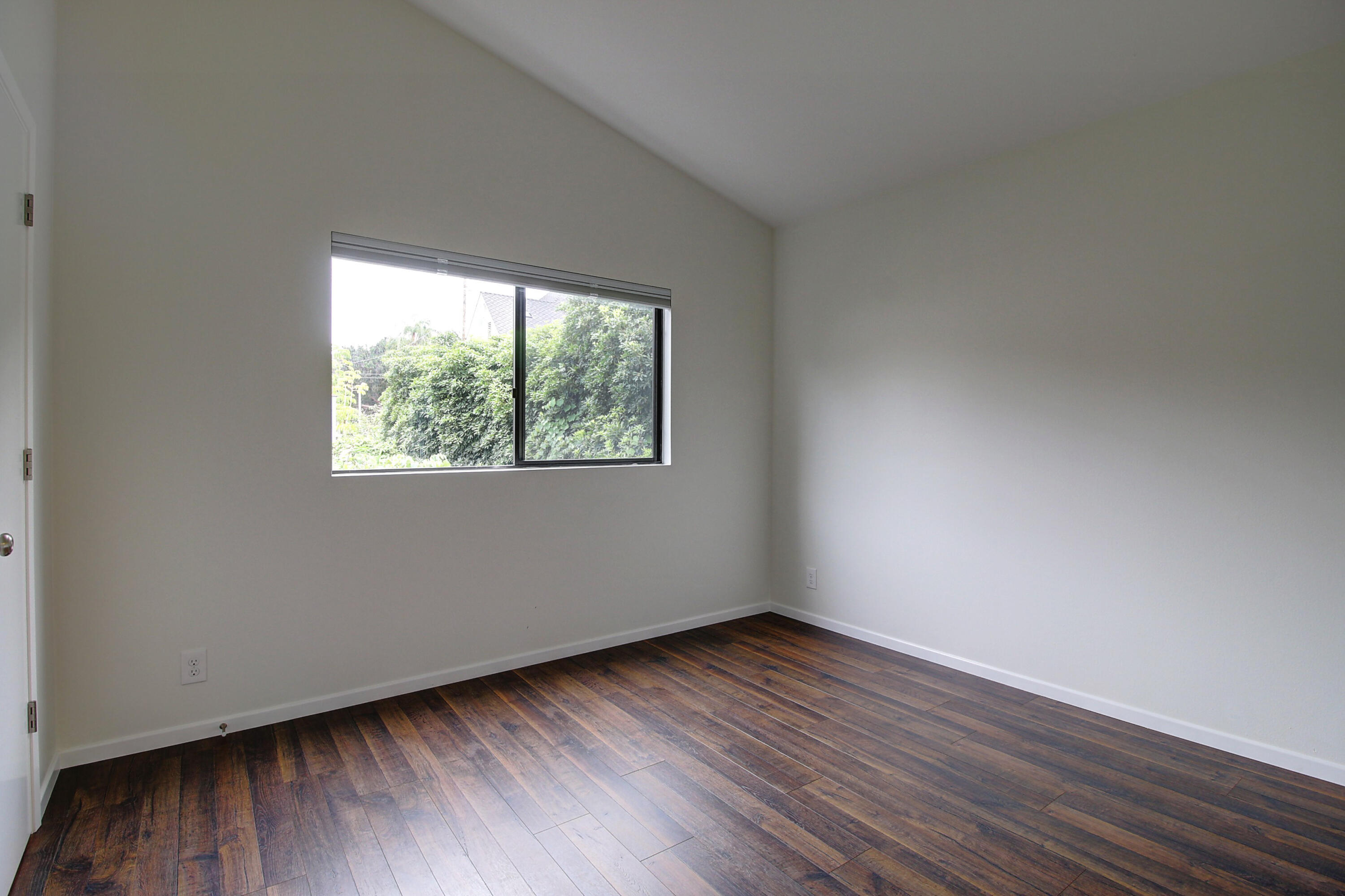 1624 Bath Street, Unit B Santa Barbara, CA 93101 - Photo 14 of 16 a view of an empty room with wooden floor and a window