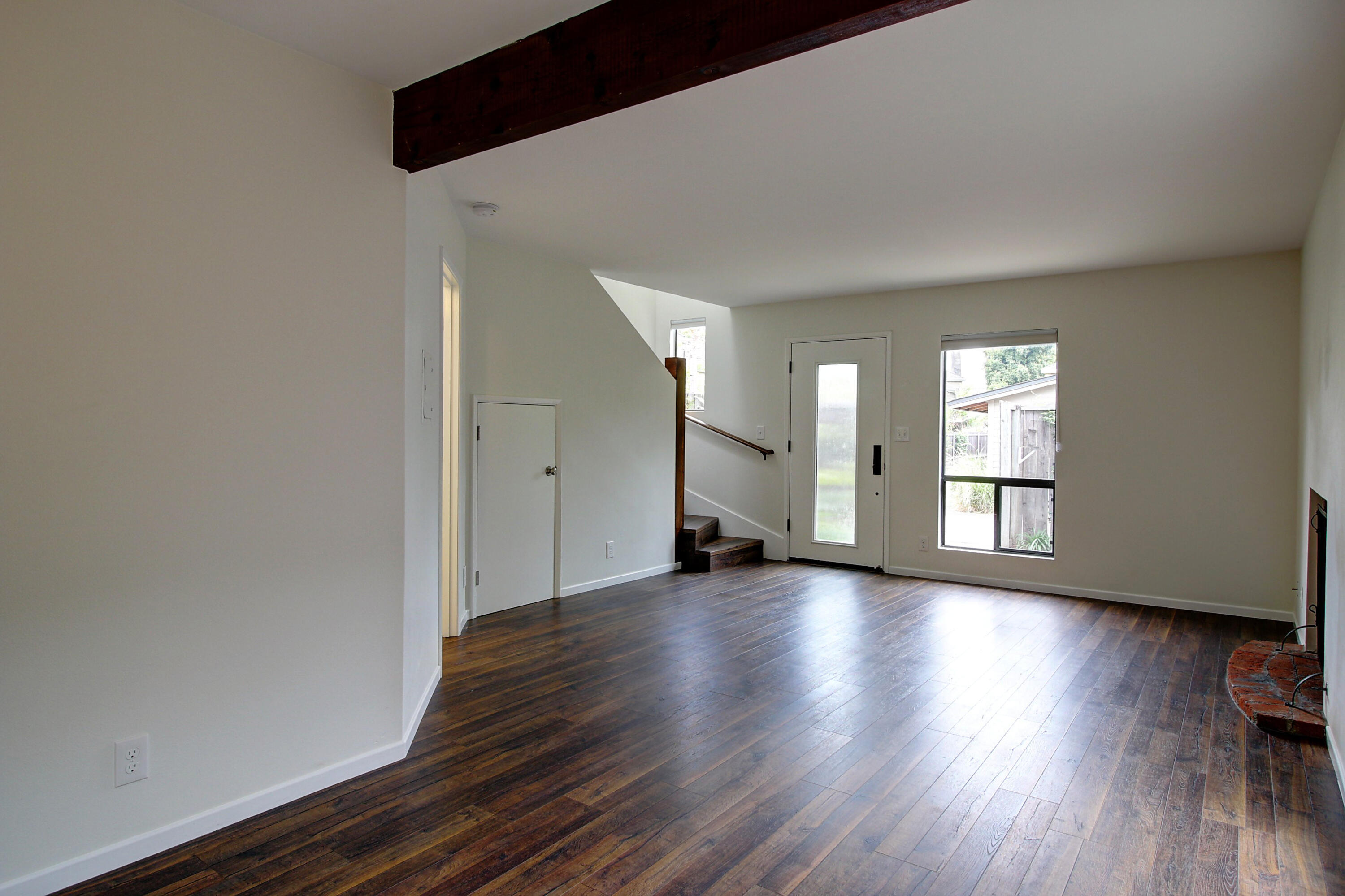 1624 Bath Street, Unit B Santa Barbara, CA 93101 - Photo 3 of 16 a view of an empty room with wooden floor and a window