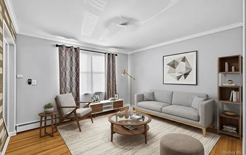 a living room with furniture a rug and a window