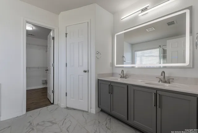 a bathroom with a granite countertop sink mirror and a