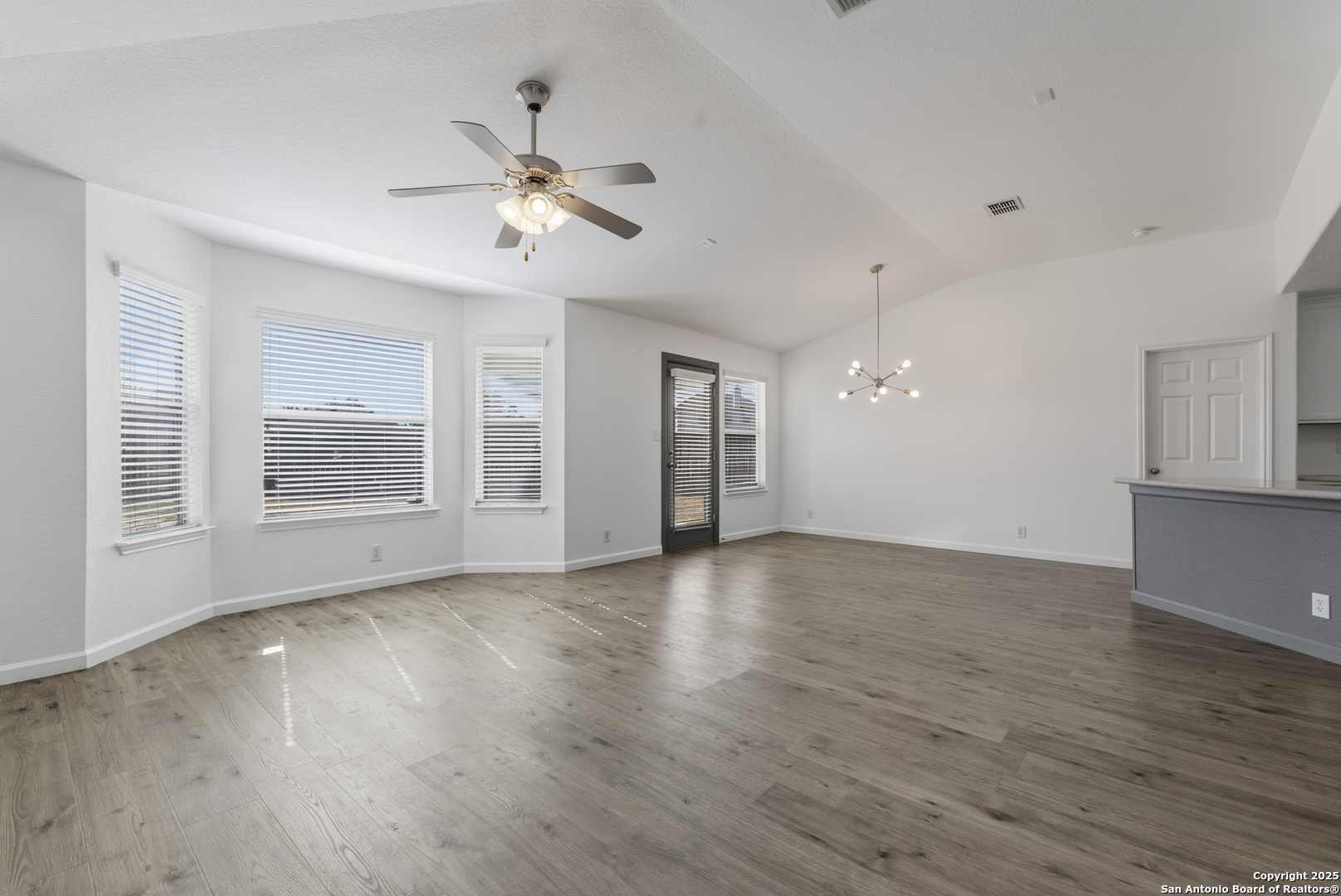 105 Lookout View Cibolo, TX 78108 - Photo 3 of 26 a view of an empty room with wooden floor and a window