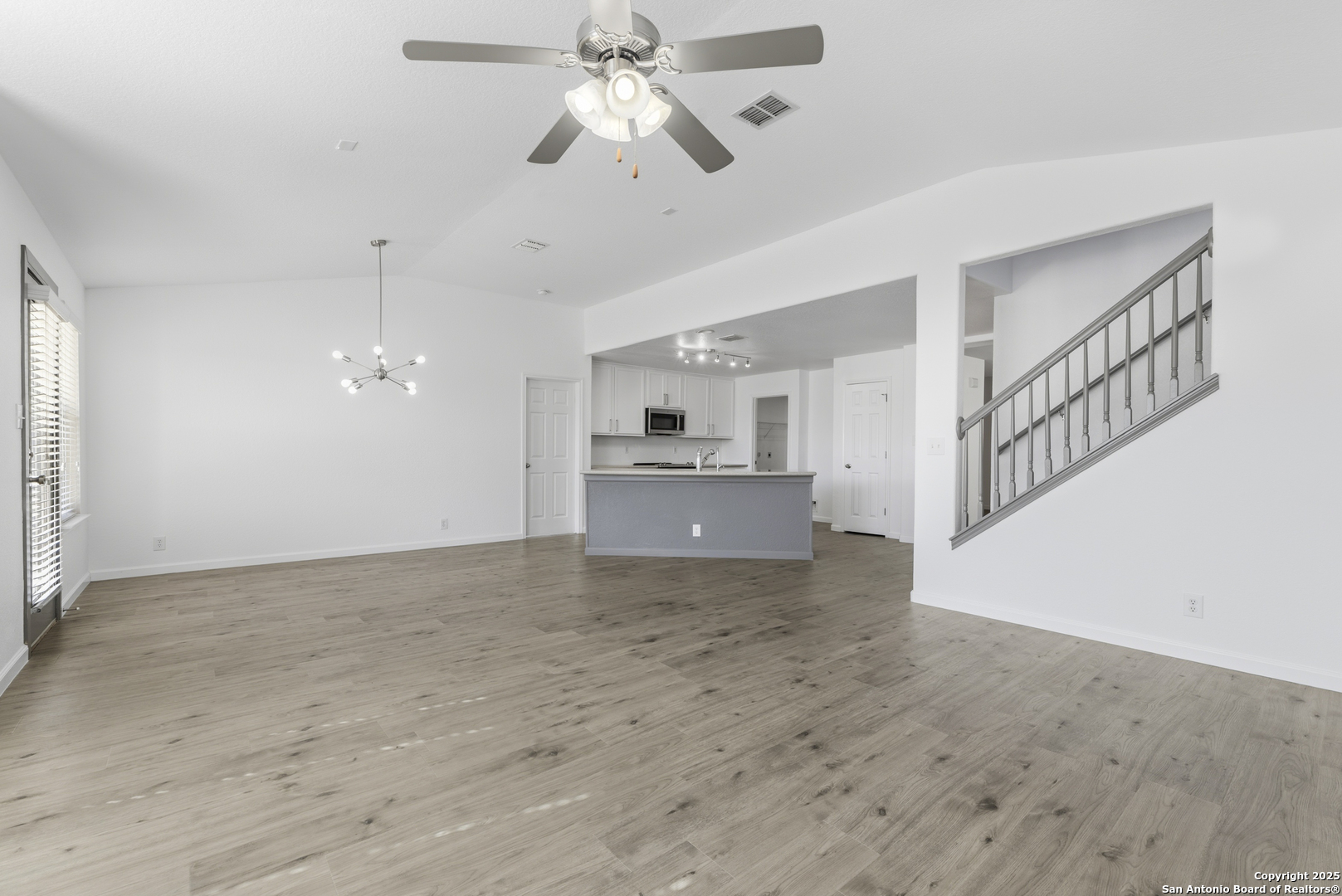 105 Lookout View Cibolo, TX 78108 - Photo 4 of 26 a view of an empty room with a window and a kitchen