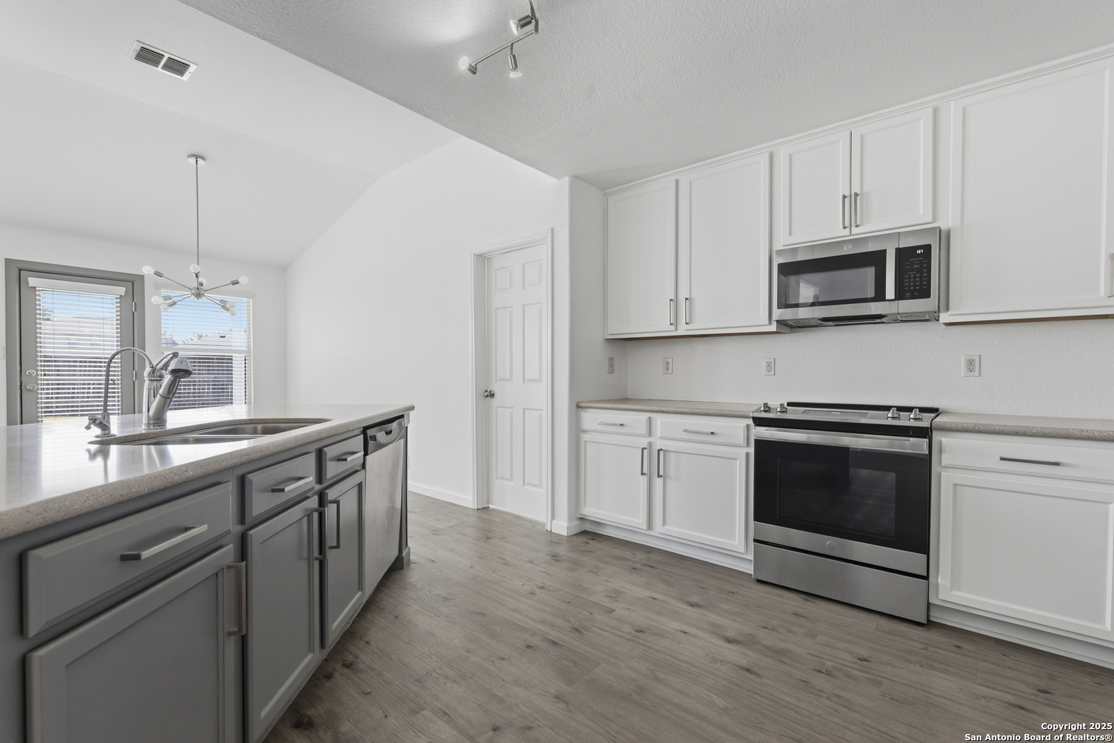 105 Lookout View Cibolo, TX 78108 - Photo 5 of 26 a kitchen with stainless steel appliances white cabinets and a stove top oven