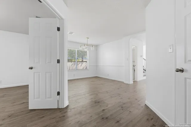 a view of a room with wooden floor