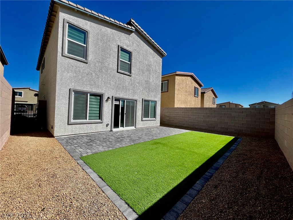 7845 Morganite Avenue Las Vegas, NV 89113 - Photo 11 of 21 A low-maintenance backyard retreat awaits with artificial turf and a generous paver patio.