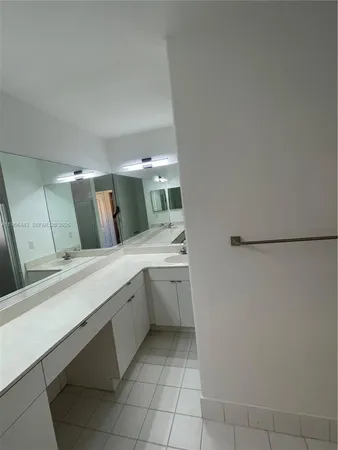 a large bathroom with a double vanity sink and mirror
