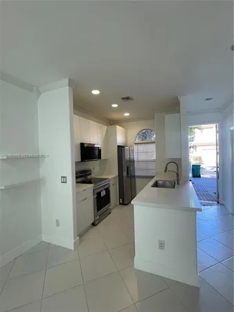 a kitchen with a sink cabinets and stainless steel appliances