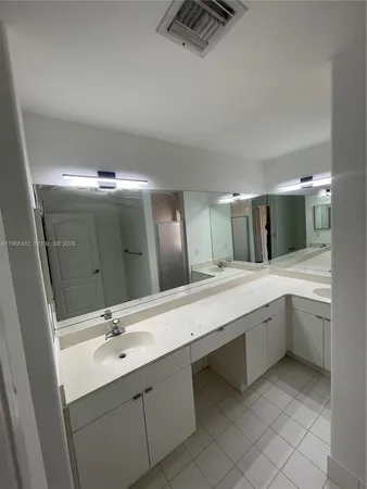 a bathroom with a sink toilet and mirror