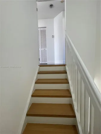 a view of bathroom with a sink mirror and window