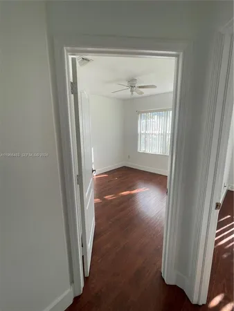 a view of a room with wooden floor