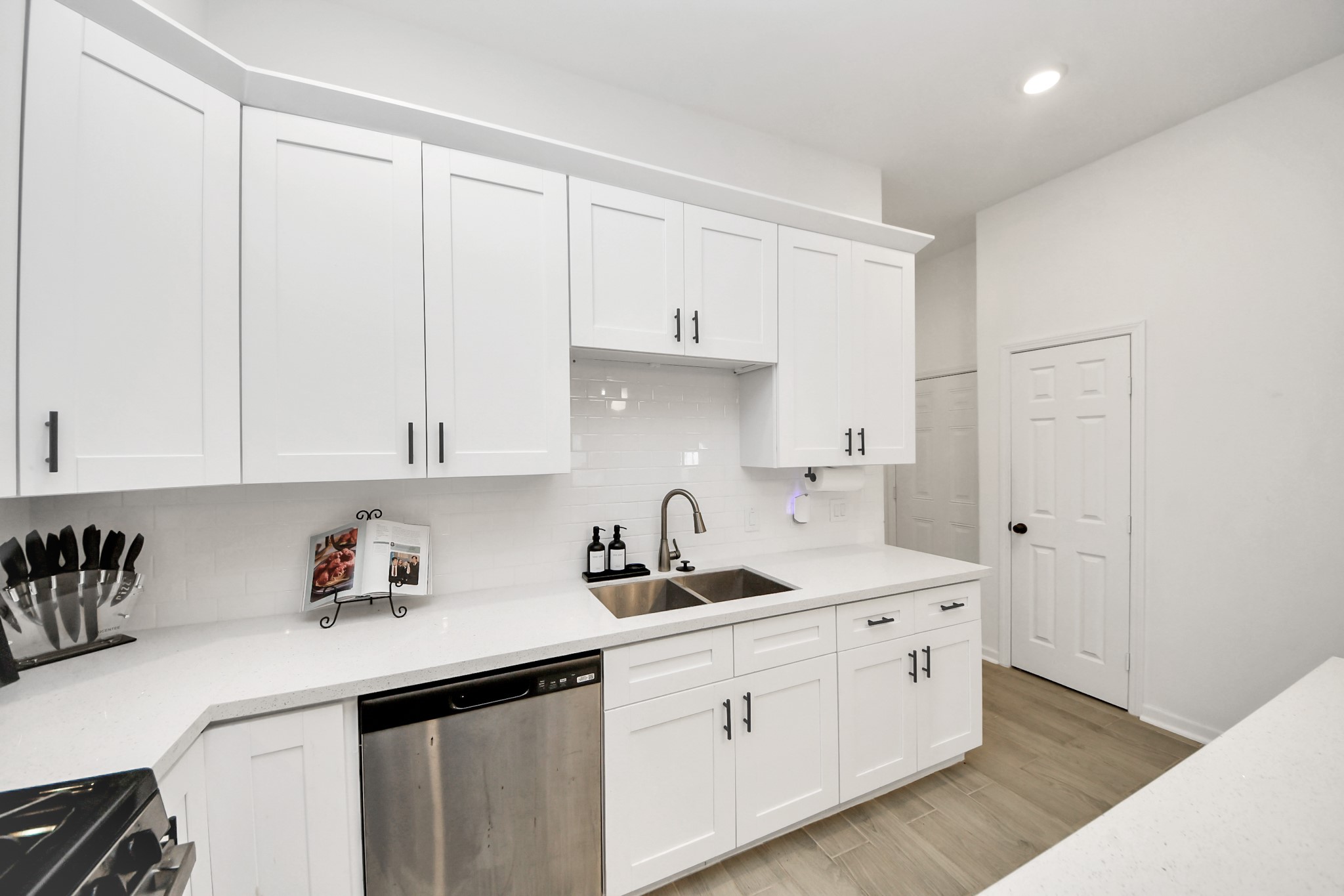 4613 Ireland Street, Unit B Houston, TX 77016 - Photo 12 of 39 a kitchen with white cabinets and sink