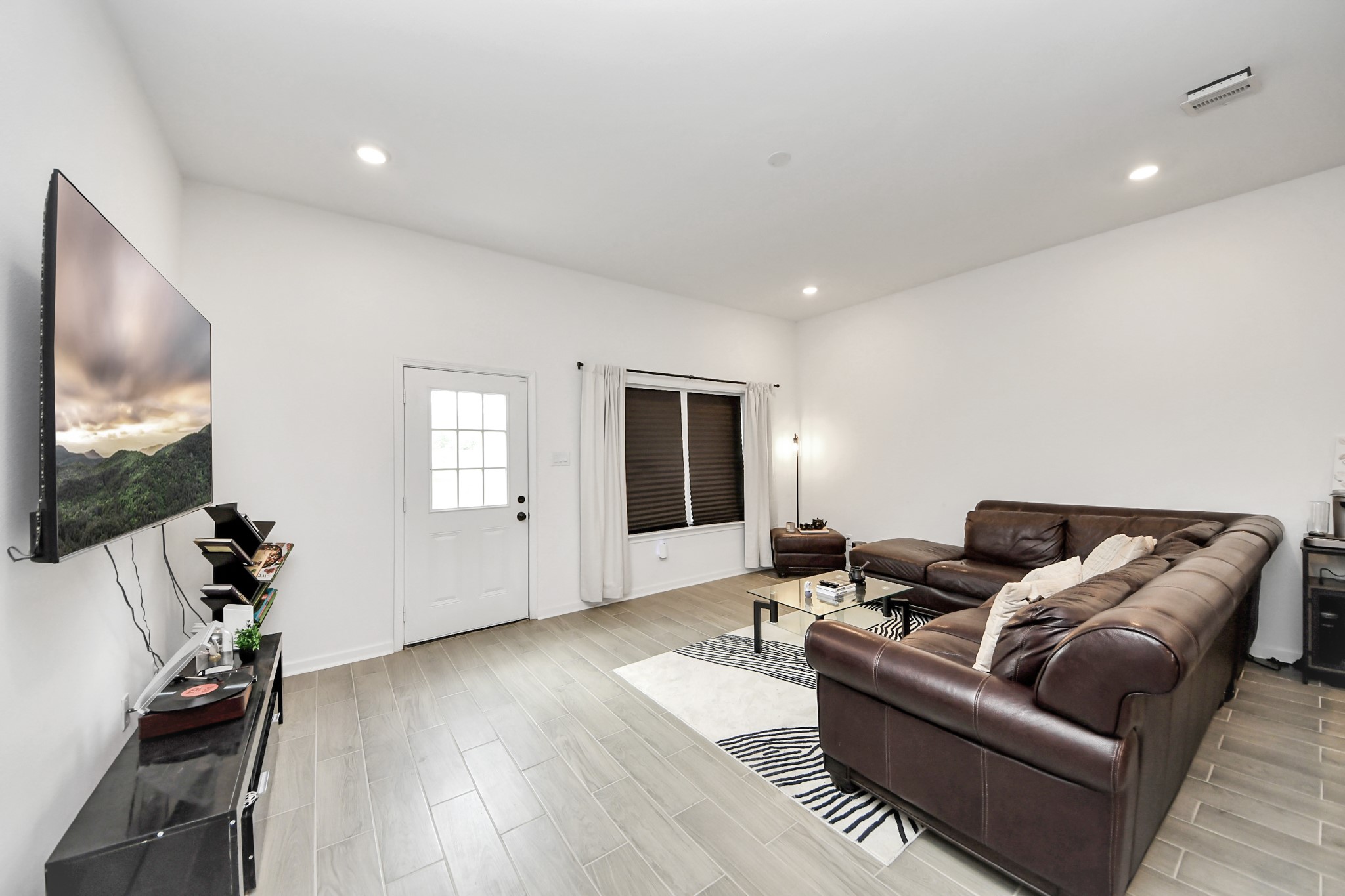 4613 Ireland Street, Unit B Houston, TX 77016 - Photo 19 of 39 a living room with furniture and a flat screen tv