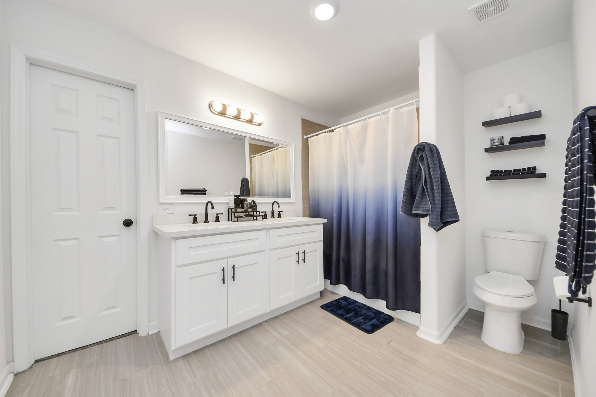 4613 Ireland Street, Unit B Houston, TX 77016 - Photo 28 of 39 a bathroom with a double vanity sink toilet and shower