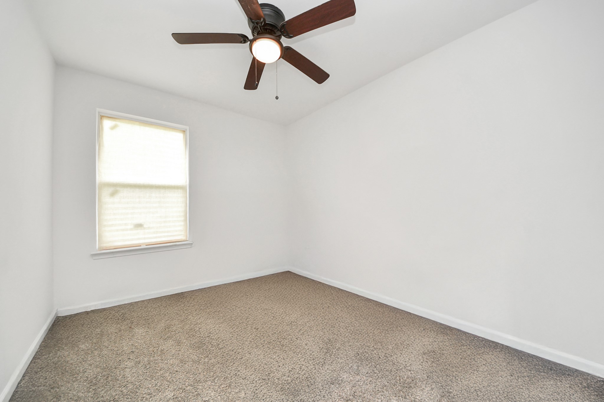 4613 Ireland Street, Unit B Houston, TX 77016 - Photo 30 of 39 an empty room with a window and a fan