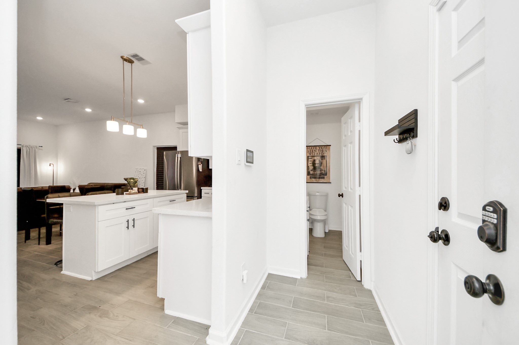 4613 Ireland Street, Unit B Houston, TX 77016 - Photo 3 of 39 a view of a kitchen with kitchen island stainless steel appliances wooden floor cabinets