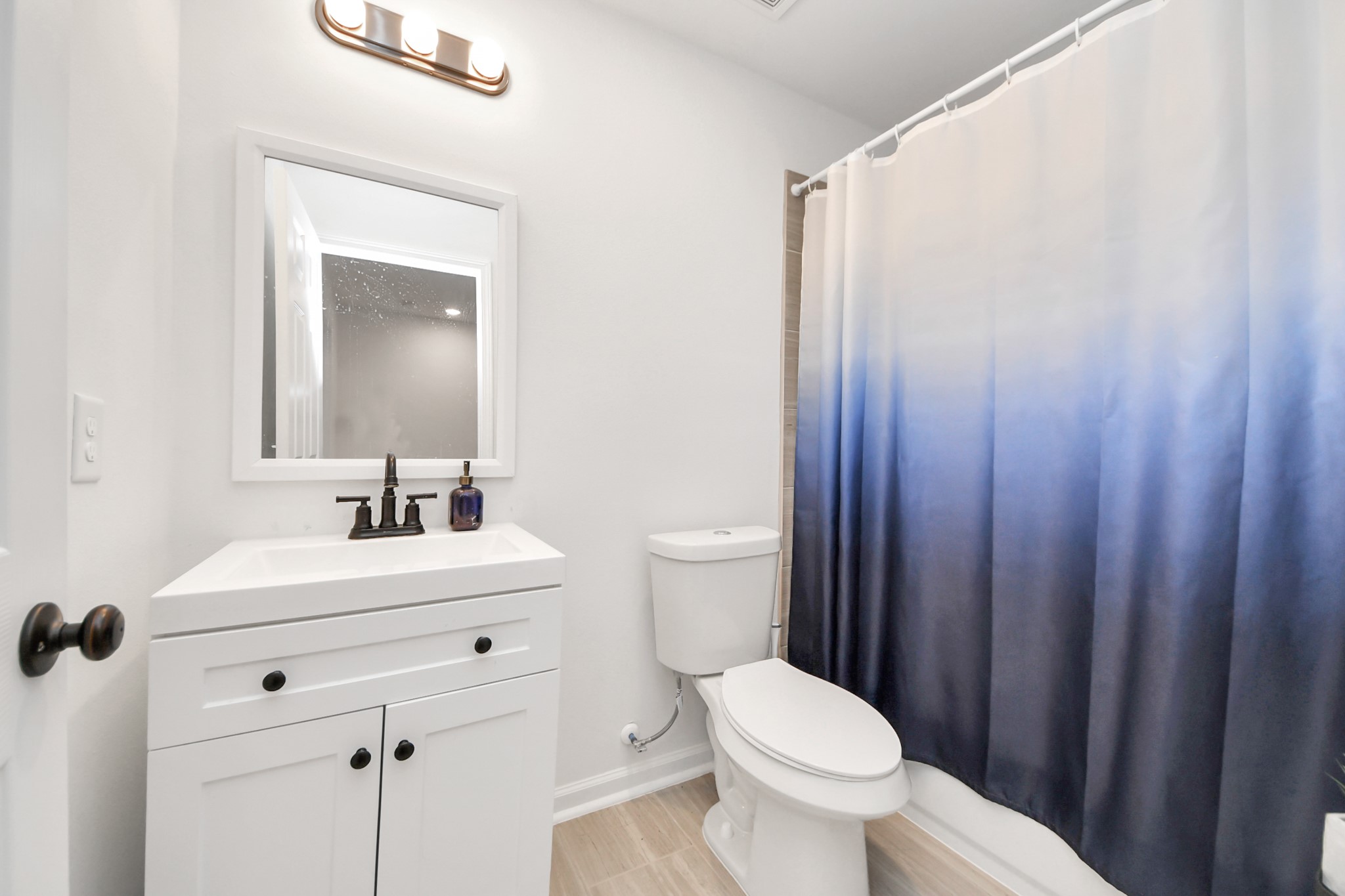 4613 Ireland Street, Unit B Houston, TX 77016 - Photo 33 of 39 a bathroom with a sink a toilet and a mirror