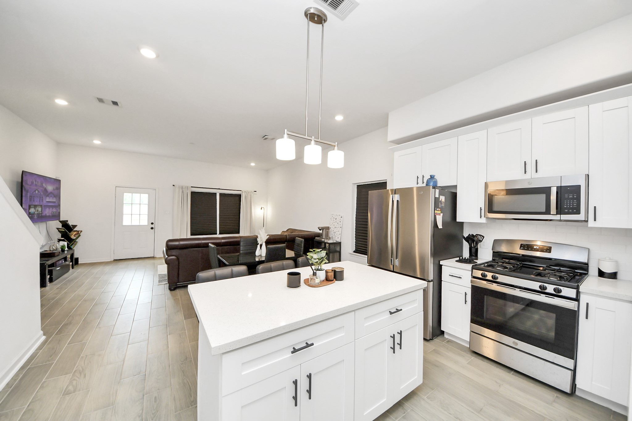 4613 Ireland Street, Unit B Houston, TX 77016 - Photo 7 of 39 a kitchen with stainless steel appliances a stove sink microwave and refrigerator