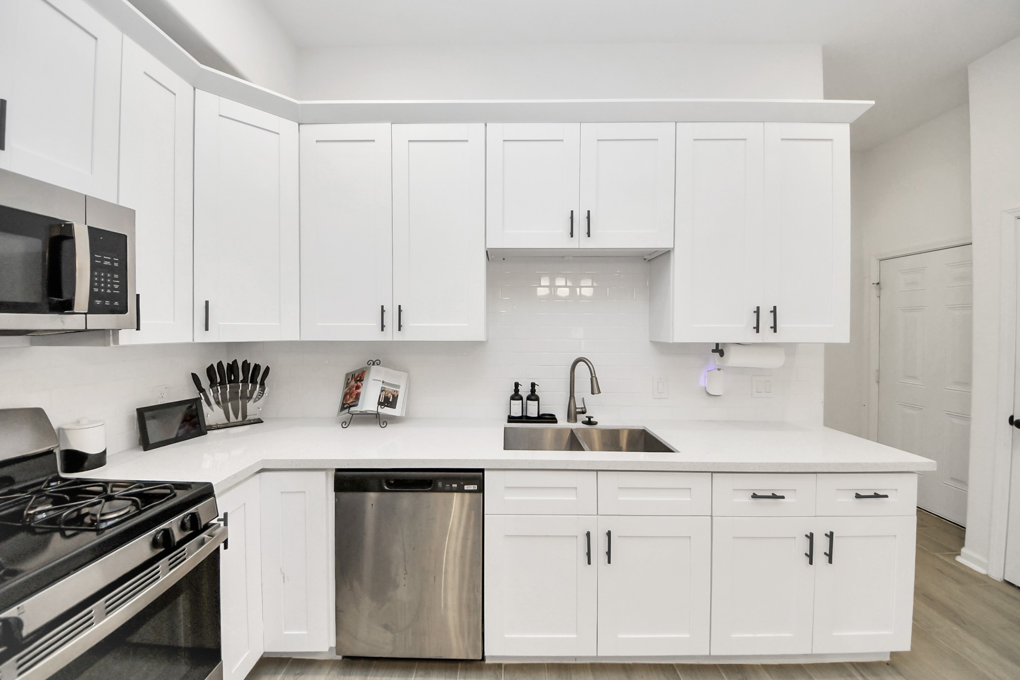4613 Ireland Street, Unit B Houston, TX 77016 - Photo 9 of 39 a kitchen with white cabinets and appliances